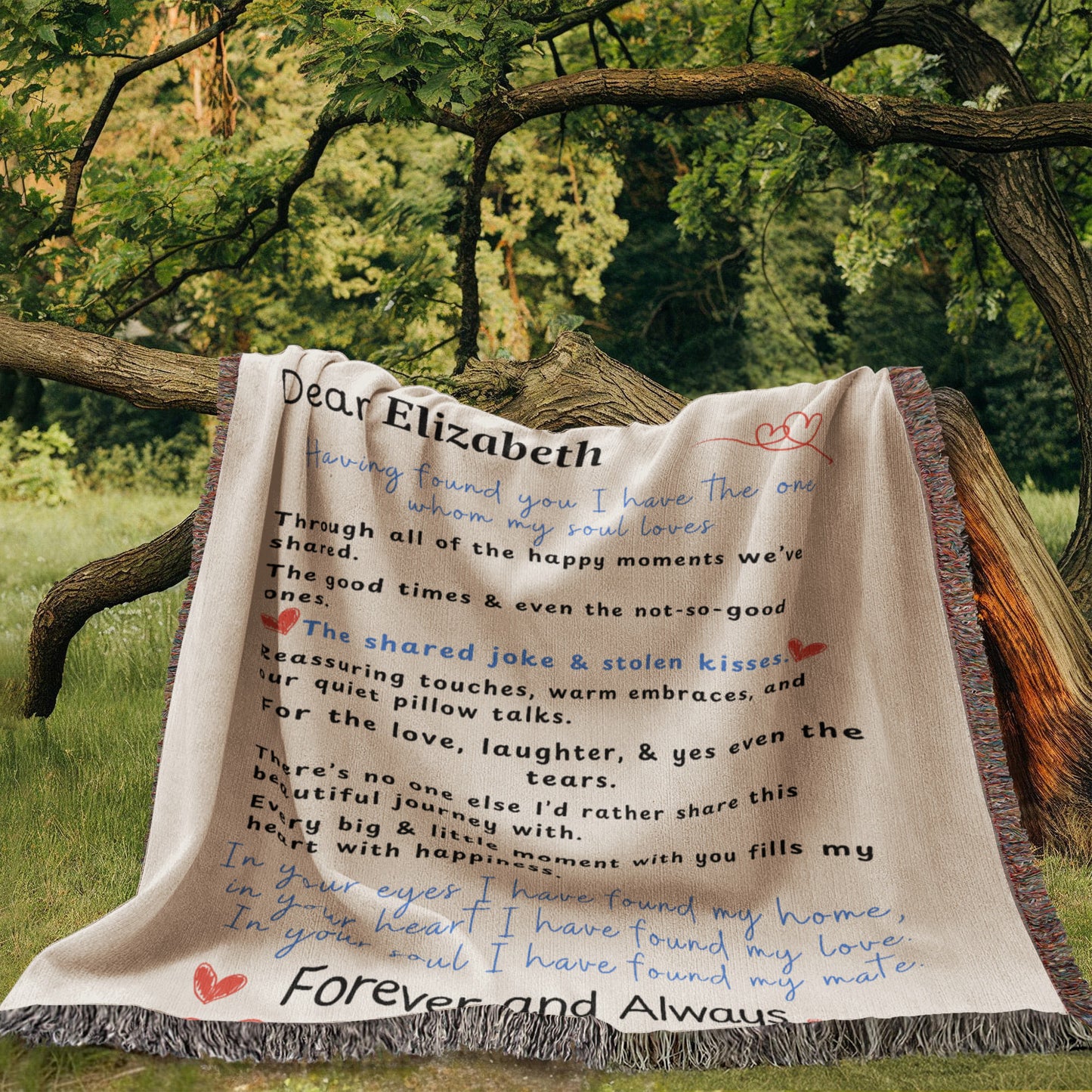A family heirloom blanket it is a love letter. A Personalize Gift with custom names laying over a tree limb out side with forest background.
