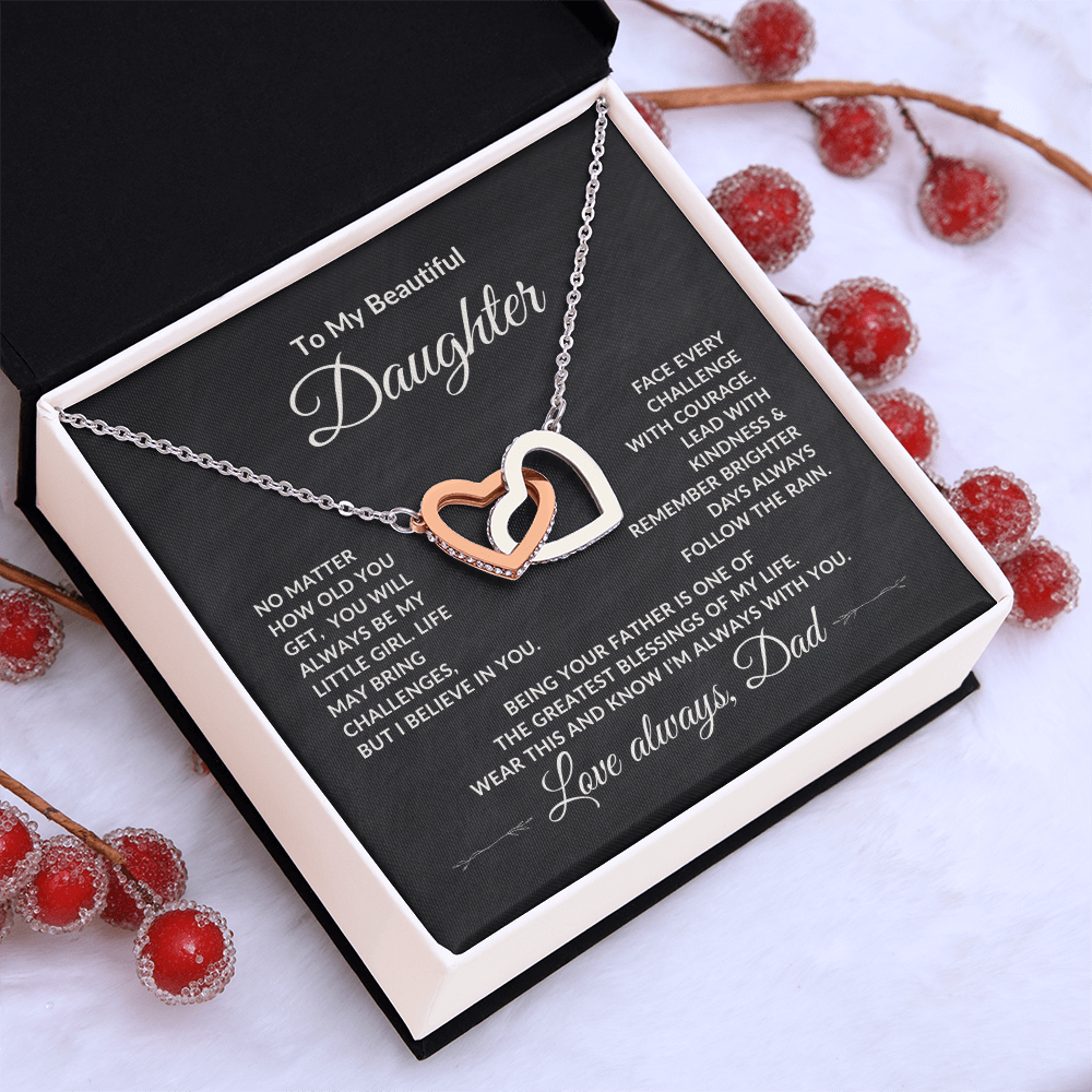 Meaningful keepsake gift for Daughter from Dad featuring Interlocking Hearts Necklace laying on a table.