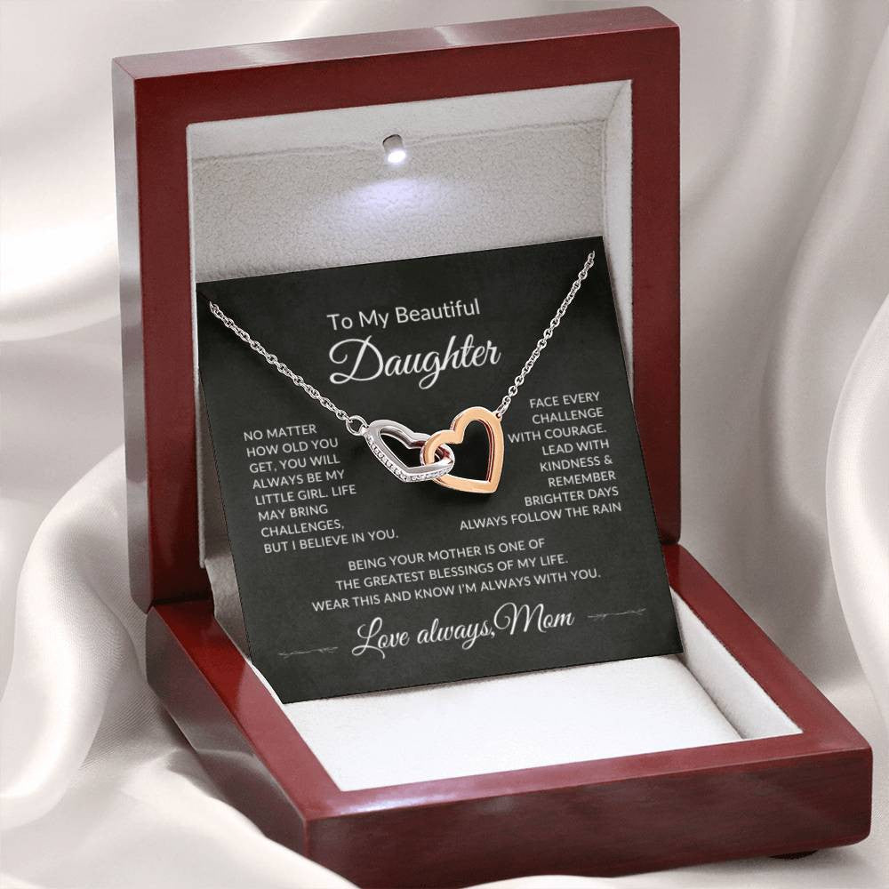 Interlocking hearts necklace displayed in luxury gift box with LED light visiable for daughter from mom