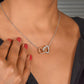 Interlocking hearts necklace worn close up, meaningful daughter gift from mom