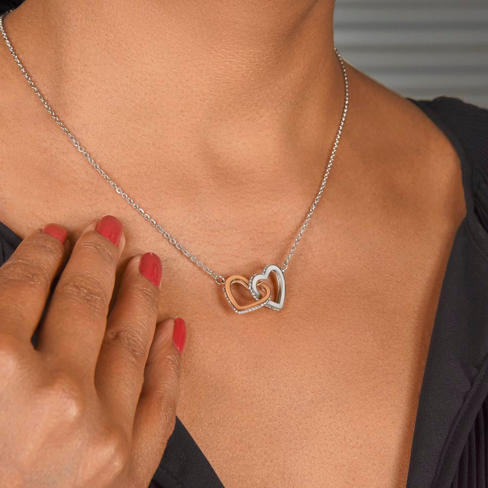 Interlocking hearts necklace worn close up, meaningful daughter gift from mom