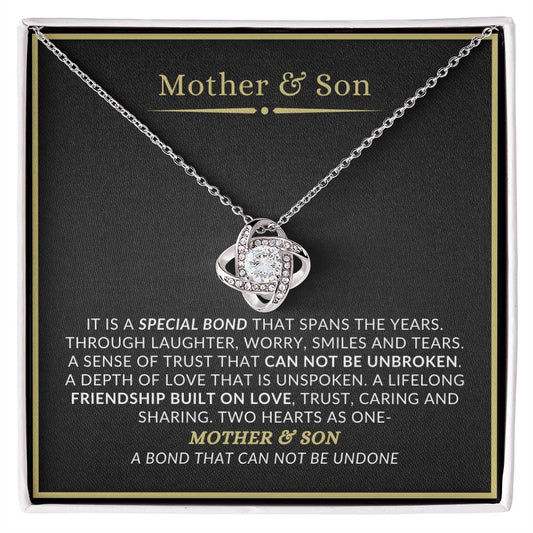 A necklace with a heart-shaped pendant, given as a gift for Mother and Son, presented in a box with a message card.