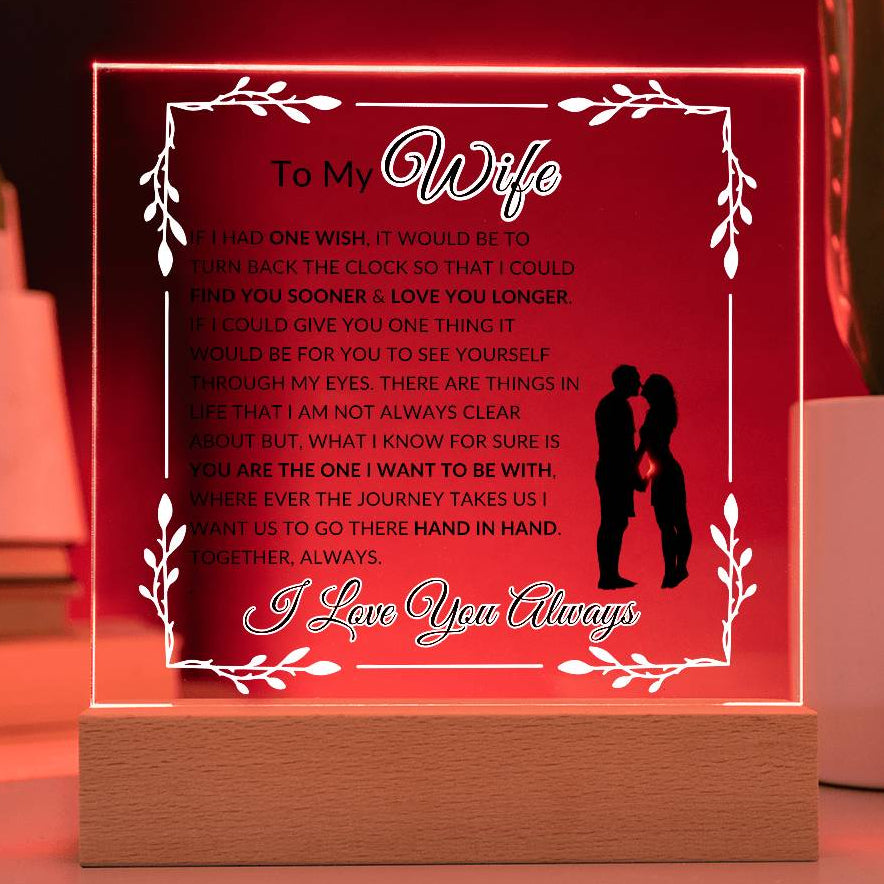 Romantic soulmate LED acrylic lamp displayed on bedroom nightstand at night with soft red glow